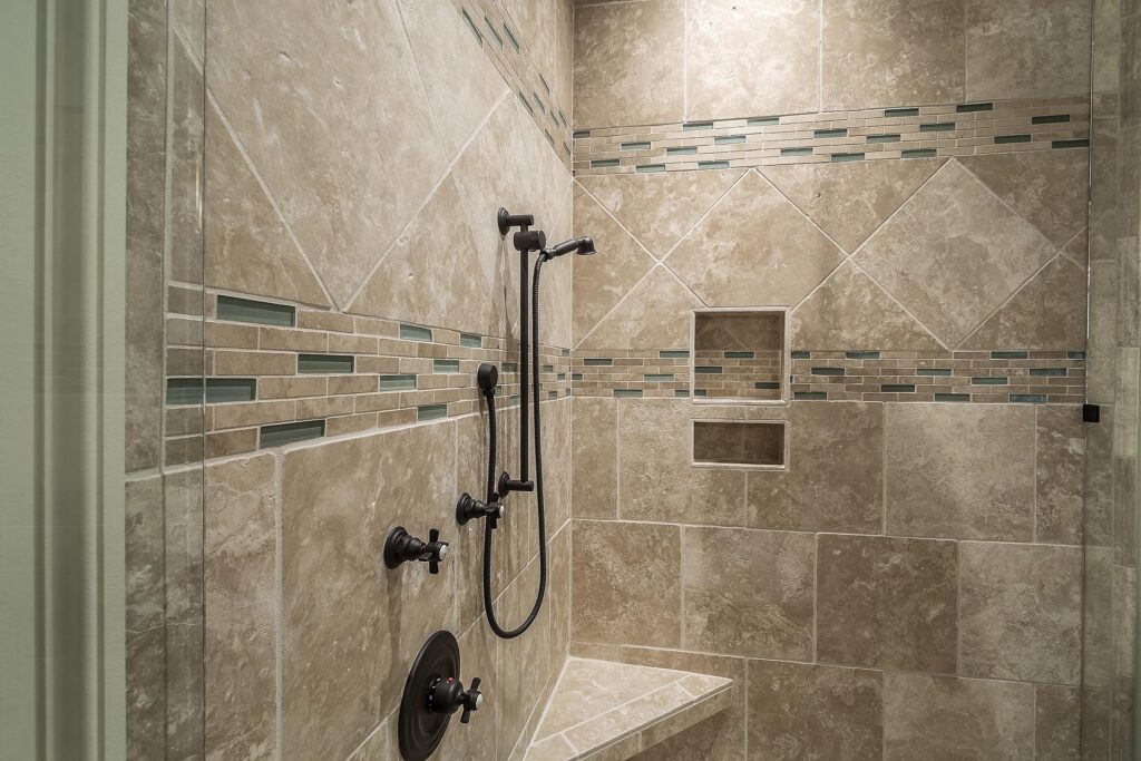 Nowoczesna kabina prysznicowa typu walk-in wykończona płytkami ceramicznymi